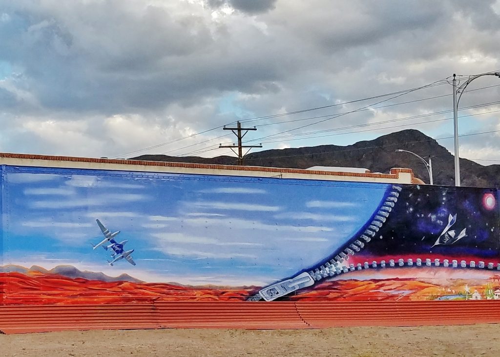 A mural of an airplane flying over the ocean.